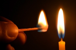 Holding Matches and candle fire on black background